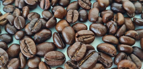 Closeup of fresh roasted coffee beans isolated on white background