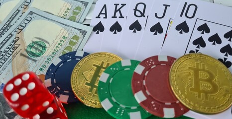 Bitcoins, cards and dices on keyboard closeup