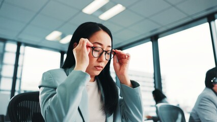 Tired, glasses and business with Japanese woman in office for fatigue, anxiety and burnout. Frustrated, mistake and fear with female employee in corporate firm for headache, overworked and stress