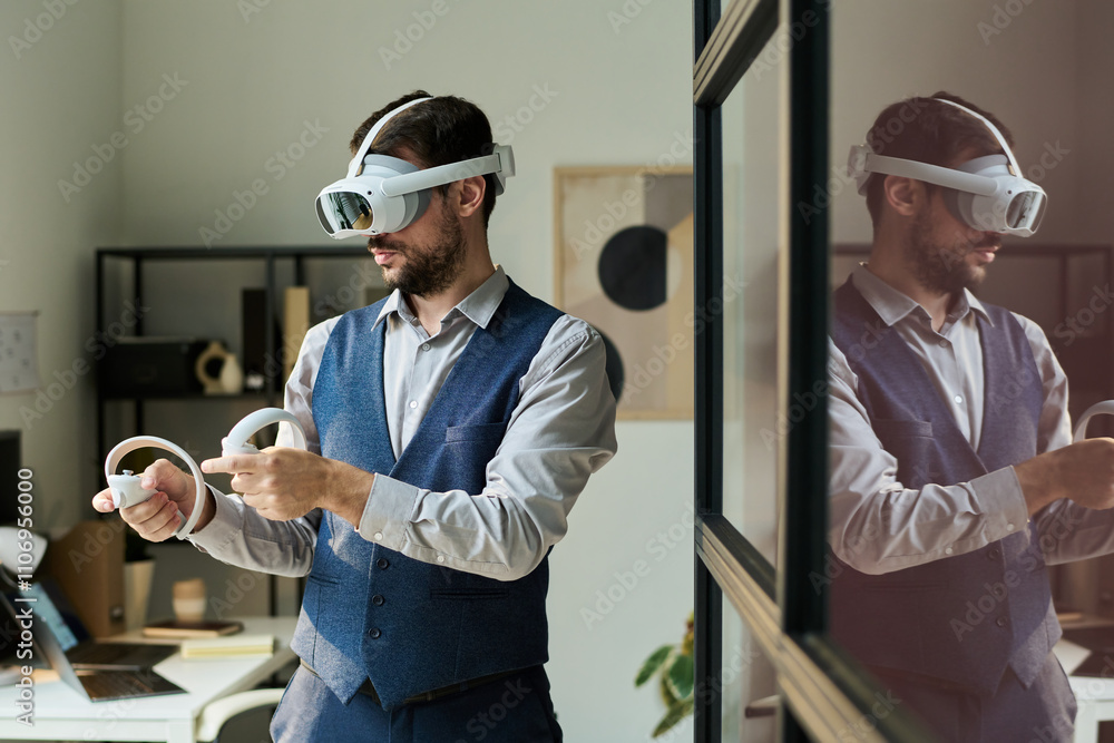 Poster Businessman wearing VR headset pressing buttons on remote controllers while making presentation of new project