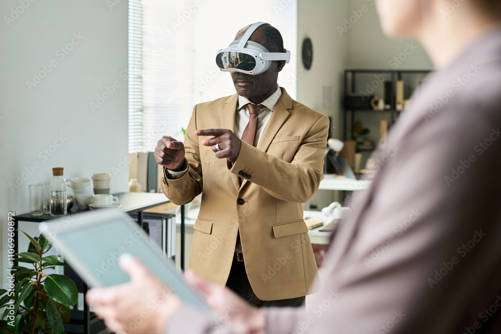 Poster focus on senior male professional in vr headset pointing at interactive board while making or prepar