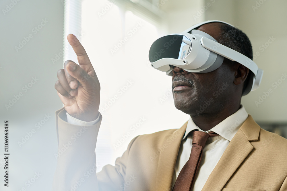 Poster aged african american businessman with virtual reality headset pointing at augmented visual board wh
