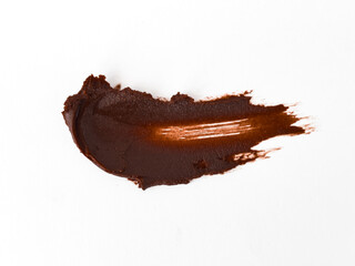 Smooth dark chocolate spread on white background