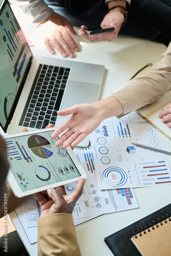 Poster high angle of hand of unrecognizable businesswoman pointing at financial document on screen of table