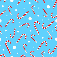 Vector seamless pattern with Christmas candy canes and white circles on a blue background