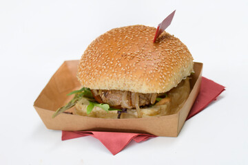 Photo of real hamburger in cardboard packaging on white table isolated
