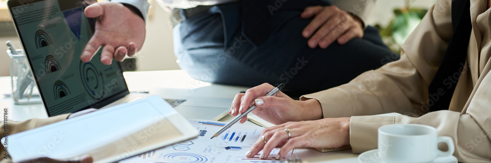Poster banner of hands of young unrecognizable female broker pointing at paper document with financial grap