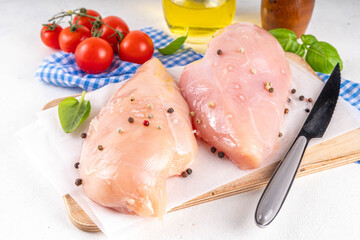 Raw uncooked chicken breast fillet on cooking table