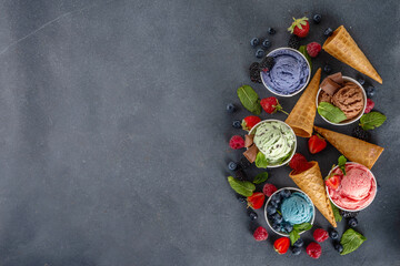 Colorful bright ice cream on bowls, with waffle cones