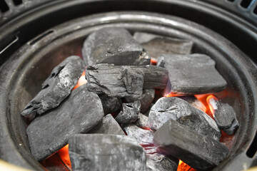 Burning charcoal in a brazier, closeup of photo