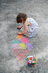 Fototapeta premium little girl drawing by chalks