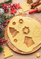 Preparing christmas cookies with dough, cutters, and festive decorations
