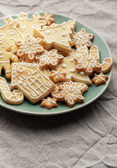 Christmas cookies with white icing forming various shapes lying on a plate