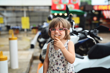 Fototapeta premium Little girl with ice cream. Thailand