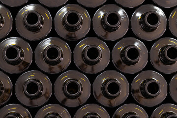 Close-up of dark glass bottle necks in food production facility