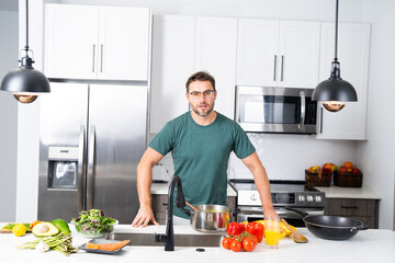 modern chef in professional uniform. close-up on the hand of male chef who is stirring soup in pot with spoon. cooking, culinary and people concept - male chef in toque with pot or saucepan.