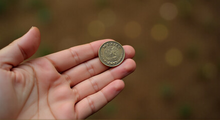 hand holding euro coin
