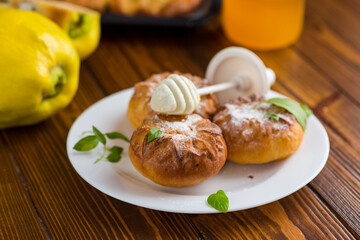 Pastries. Sweet buns with quince and honey filling, on a wooden table