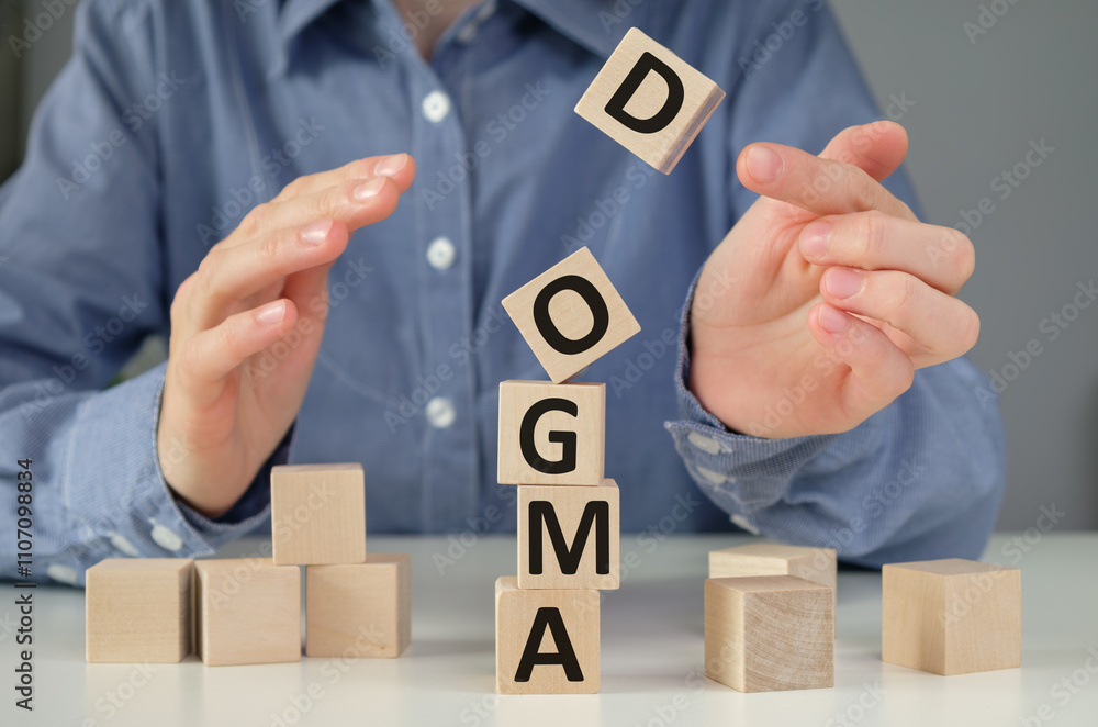 Poster dogma text on the wooden block with notebooks, keyboard with chart