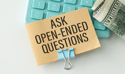 Ask Open-Ended Questions written on a notebook page, pencil on the left. Motivational Concept image.