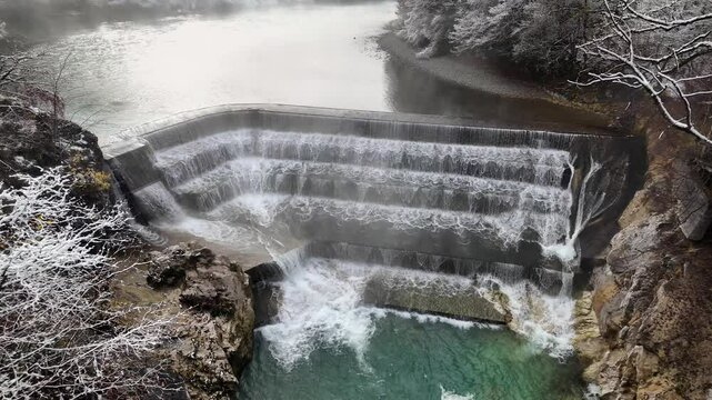 Slow-motion video of Lechfall waterfall during winter, with a foggy background