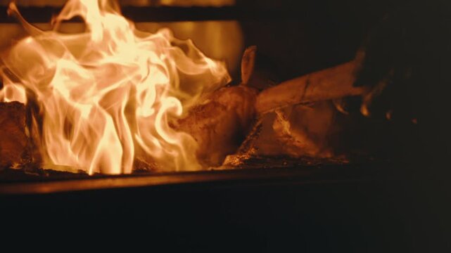 Flipping tomahawk steak in extreme slow motion on outdoor grill, flames and huge cut of beef in 4k 800fps