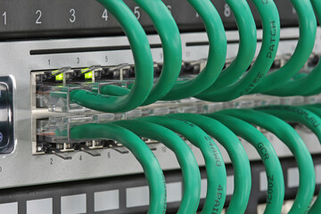 Connecting the Ethernet switch to the patch panel using patch cords with Rj45 tips.