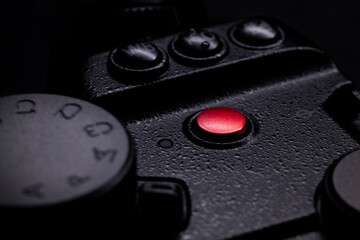 latest generation mirrorless camera close-up black white and red buttons and light reflected menu symbols