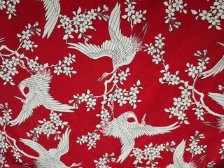 White cranes on red fabric 