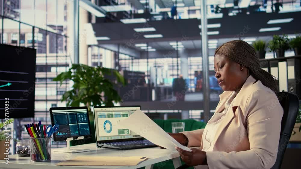 Poster black influential businesswoman evaluates company performance, using data reports and analytics to m