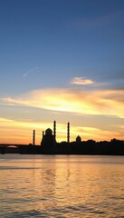 a large body of water with a bridge in the background