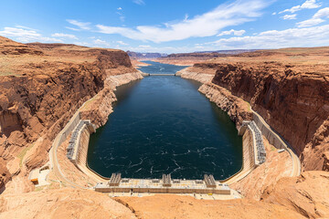 Wide angle view of dam surrounded by rocky cliffs and water