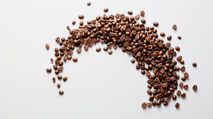 Coffee beans scattered in a crescent shape on a white background, emphasizing motion