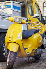 yellow scooter on the background of a yellow car cabin