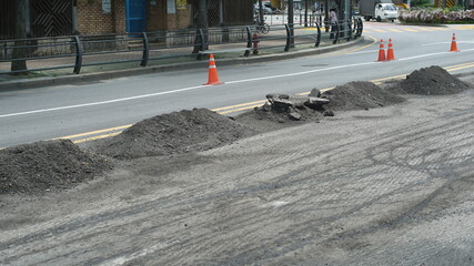Road under construction with asphalt debris piled up