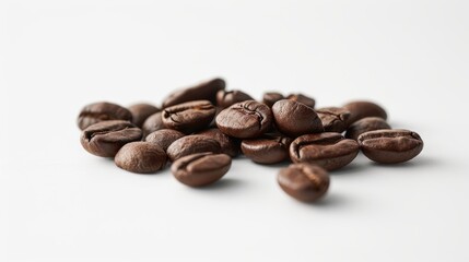 Naklejka premium Coffee beans in a random cluster on a white surface, highlighting their natural shapes