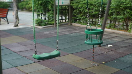 Normal and Toddler swing at public playground