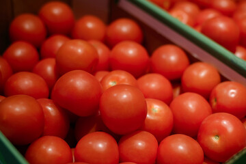 A vibrant display of fresh, ripe red tomatoes, showcasing their smooth skin and rich color. Perfect for healthy food, vegetable, or garden harvest concepts.