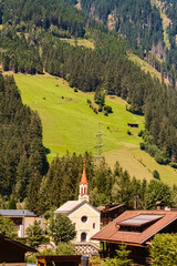 Fototapeta premium Alpine summer view with a church near Ginzling, Zillertal valley, Schwaz, Zell am Ziller, Tyrol, Austria