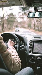 A person is driving a car with a GPS system