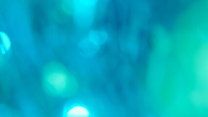 Blurred blue green lens flare motion studio lightning, garland with bokeh effect on dark...