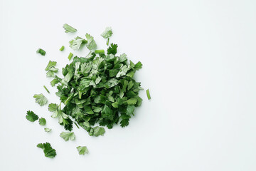 Fototapeta premium A pile of chopped parsley sits on a white background