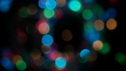 Blurred rainbow colored lens flare motion studio lightning, garland with bokeh effect on black background. Light leaks shining, abstract background footage.