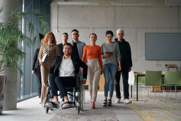 A diverse group of business professionals walking together through the office, symbolizing unity and strength as a collaborative and successful team