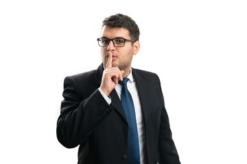 Adult businessman covering mouth making secret shush gesture