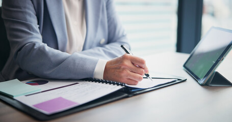 Business person, hands and writing with tablet for analytics, planning or corporate statistics at office. Japan, financial analyst and technology with documents or paperwork for performance review