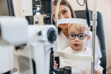 In the ophthalmologist cabinet. Little boy is having check up