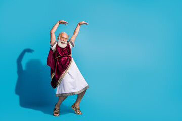 Photo of ancient imperial greek charter wearing traditional toga having fun empty space isolated on blue color background