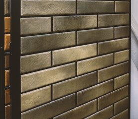 Laying vintage wall tiles imitating brickwork.