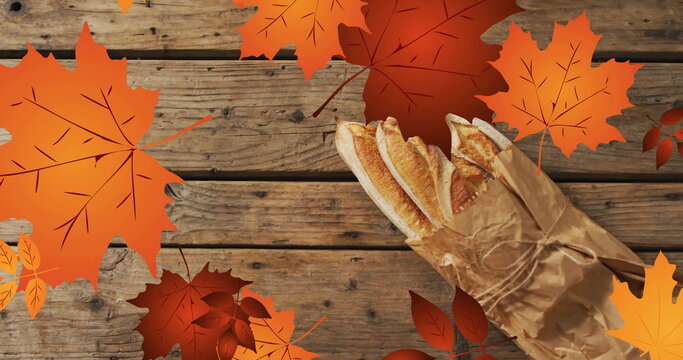 Image of frame with fall leaves over baguettes